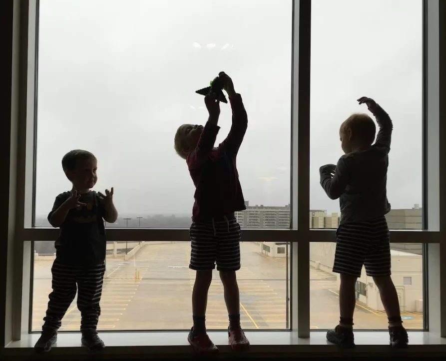 Kinderen wachten op de luchthaven tijdens een gezinsreis naar België